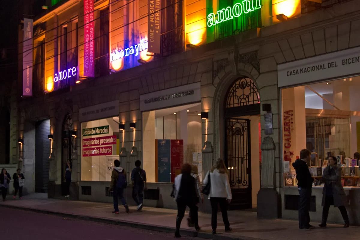 The Casa Nacional del Bicentenario's façade lit in coloured neon for the Night of the Museums, visitors on the pavement