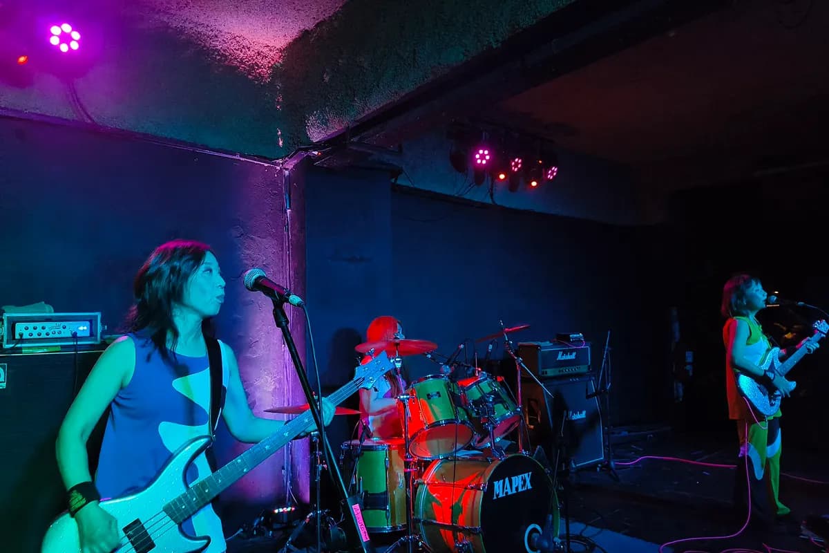 A band on the small stage of Club Cultural Bula under coloured lights