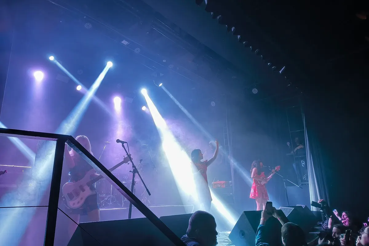 A band on the Niceto Club stage under white and blue spotlights